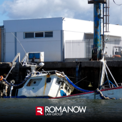 A damaged boat sinking into the water in Portland, ME