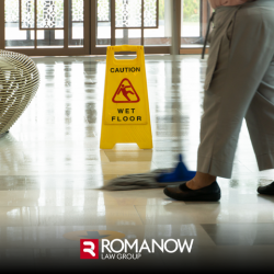 Wet floor sign with a person mopping nearby, the setting for a possible slip and fall accident