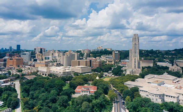 Aerial view of the University of Pittsburgh campus with the Cathedral of Learning and surrounding city buildings.